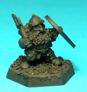 Pose 1. This low-level character figure wears a simple chainmail hauberk and a cross-banded steel cap. He carries a variety of adventuring gear strapped to a sturdy leather backpack, and he wields a plain handaxe in his right hand.