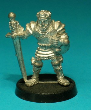 Pose 1. This figure wears full plate armour, with a chainmail coif and a small crown. He has a large chalice tied to his belt, and he holds a large two-handed sword with the point by his right foot.
