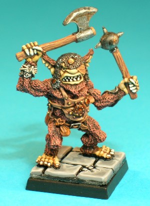 Pose 1, variant A. This Bugbear wears a tatty, leather breastplate adorned with studs and a small metal disc. Two leather pouches hang from his belt and he wears a steel bracer on his left fore-arm and a plate and string protector on his right wrist. His right arm holds a weapon above his head and his left arm is raised to shoulder-level. This variant has a pointed beard and an open, snarling mouth showing his vicious teeth. He has long, notched ears and wears a tatty chainmail coif and a leather eyepatch over his left eye. His head looks straight forwards, and he is armed with a single-bladed axe in his right hand and a spiked ball-mace in his left.