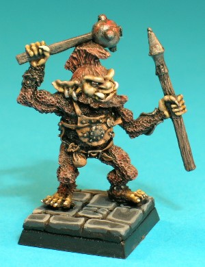 Pose 1, variant C. This variant figure has a pointed beard and a tall, mohican-style haircut, and his closed mouth has protruding lower fangs. He has long ears with a pair of plain earrings in his right and a single ring in his left. His head looks slightly left, and he is armed with a studded ball-mace in his right hand and a javelin in his left