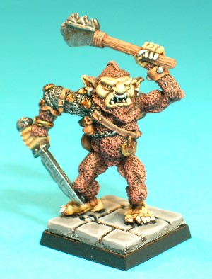 Pose 2, variant A. This Bugbear wears a tatty chainmail sleeve on his right arm, and has a variety of small pouches, chains, discs and bones hanging from a leather cross-belt. He has a studded leather vambrace on his left wrist and a fine metal bracelet on his right. His right hand holds a notched, single-bladed sword with the point by his right knee, and his left arm raises a variant weapon above his head. This variant has a pointed beard, a peaked hairstyle with a short ponytail and an open, snarling mouth showing his vicious teeth. He has long ears with a plain earring in each, and wears a large ring through his nose. His head looks slightly to his left and he wields a steel-headed mace that looks a lot like a meat tenderizer in his left hand!