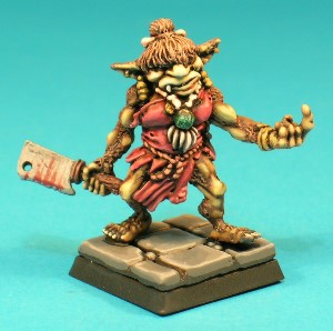 Pose 2. The Female - This figure is a Bugbear matriarch, wearing a ragged cloth dress, and adorned with a variety of primitive tribal jewellery. She wields a large meat cleaver in her right hand and her left hand gives a beckoning gesture.