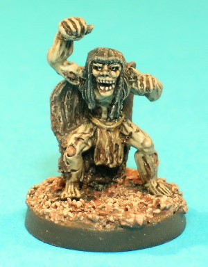 Pose 4, variant A. This figure is a Wight, an evil Undead creature much feared for its level-draining ability. It wears a tattered cloak and a loincloth. This variant has long hair, but with a short fringe. It has a near-skeletal face with its mouth wide open barring its teeth, and looks straight forwards.